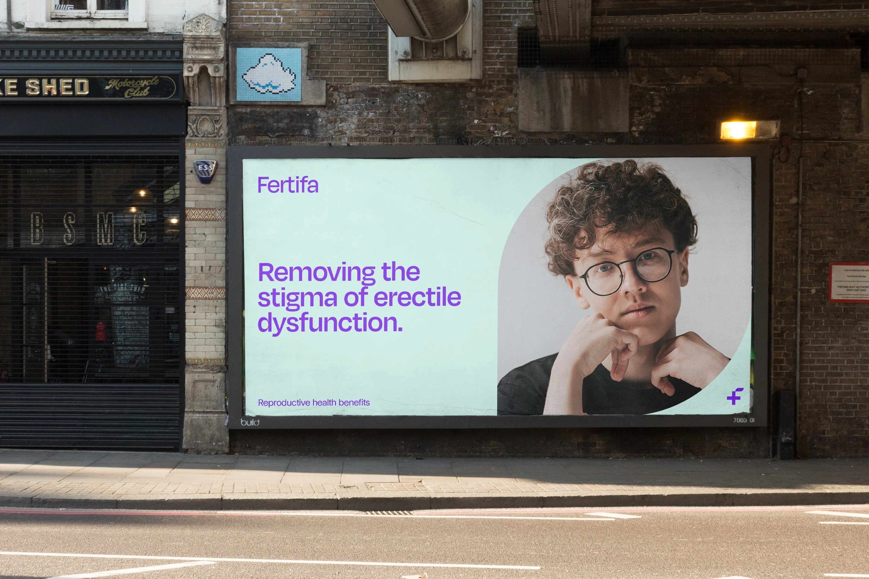 A Fertifa billboard under a railway bridge: “Removing the stigma of erectile dysfunction.”