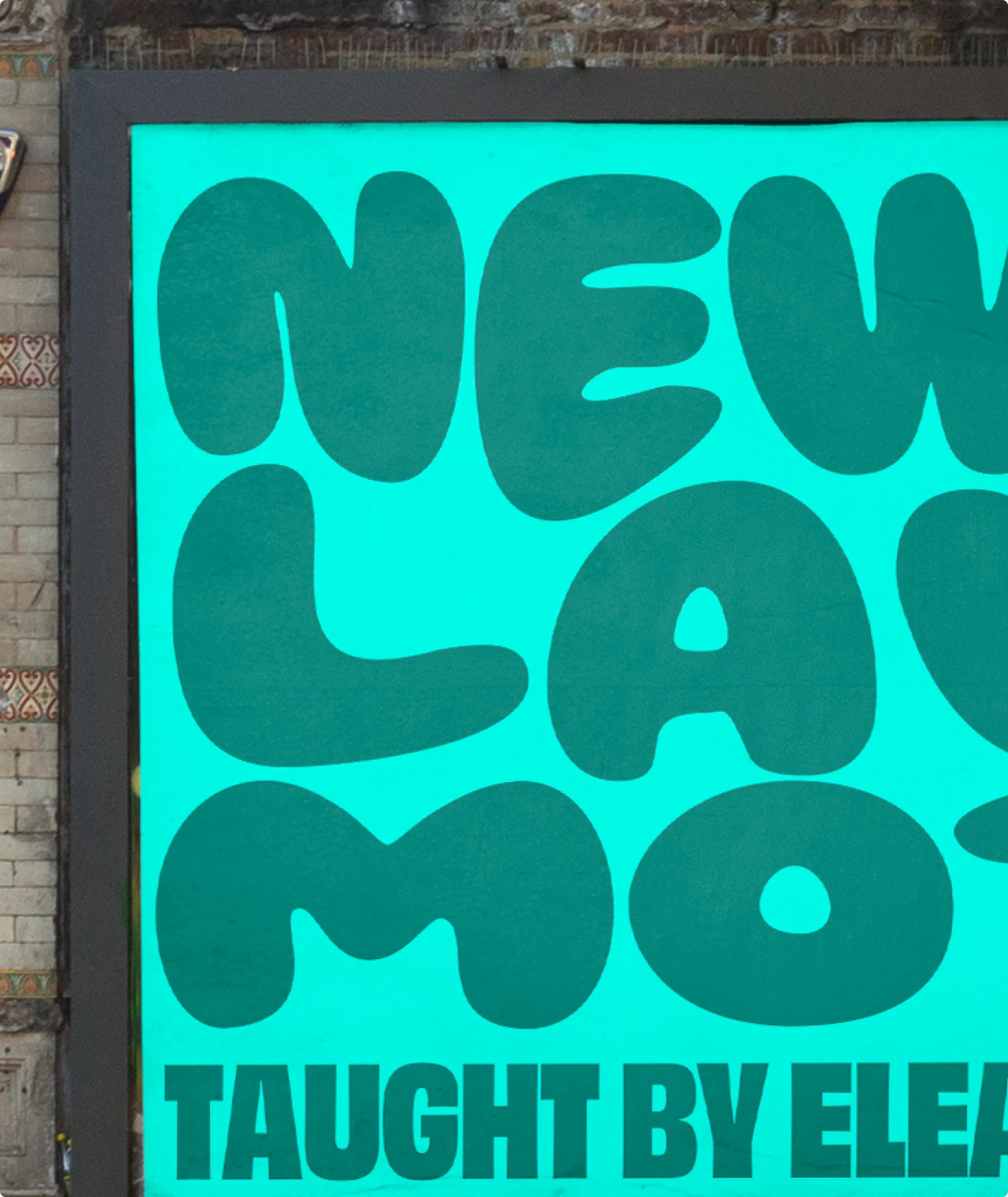 Creator Live: a billboard on a brick wall, “Newtons Law of Motion” in fat rounded letters on mint