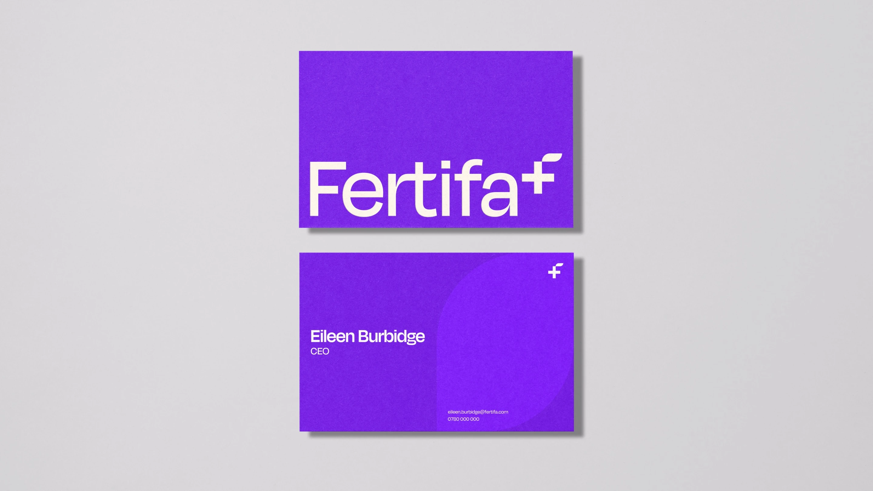 Two purple Fertifa business cards: the wordmark on the front, the CEO’s details on the back