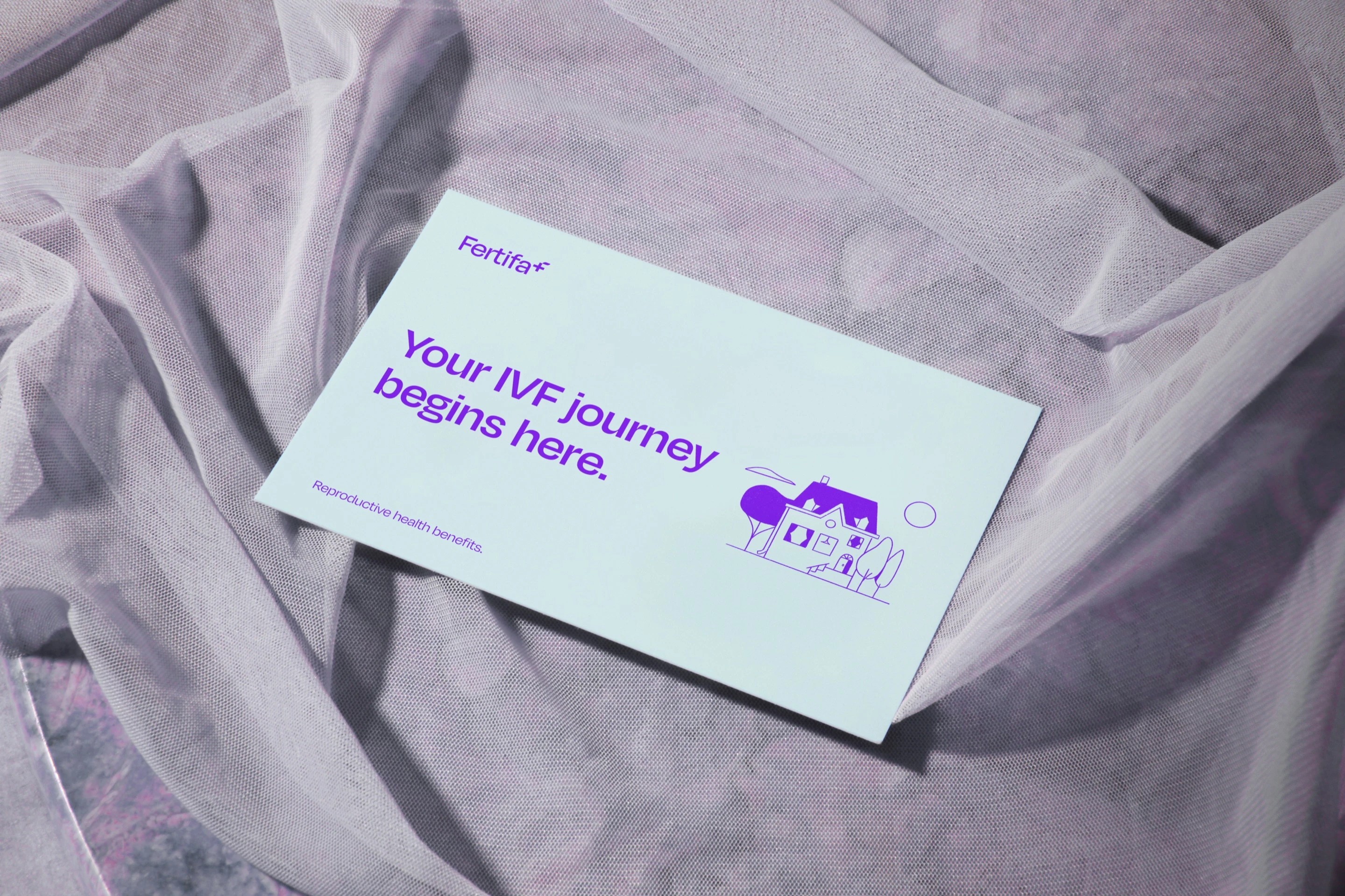 A mint Fertifa card on sheer fabric: “Your IVF journey begins here.”